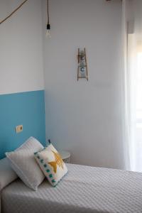 a bedroom with a bed with a pillow on it at H El Palmeral Playa in Mojácar
