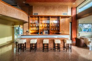 a bar in a restaurant with stools at Comfort Hotel Apartments in Rhodes Town