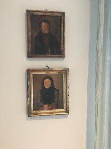 two portraits of a man and a woman on a wall at Schwanen Herz in Arnis