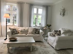 a living room with a couch and a coffee table at Schwanen Herz in Arnis