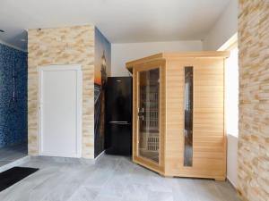 a room with a refrigerator and a door at Kóbor Vendégház in Baja