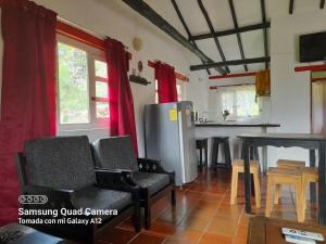 a kitchen with chairs and a table and a refrigerator at Villa Lourdes in Villa de Leyva