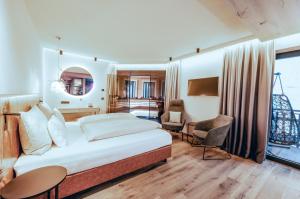 A bed or beds in a room at ZillergrundRock Luxury Mountain Resort