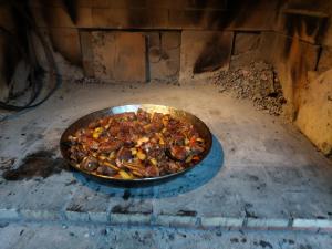 a pan of food is cooking in an oven at Guesthouse Leski Dvor in Lesce