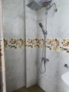a shower in a bathroom with a shower head at New 2 bedroom apartment, 100m away from the beach in Dehiwala