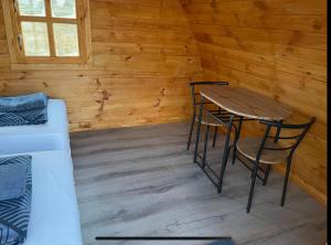a room with a table and chairs in a cabin at Starlight Camping Pods in Hvolsvöllur