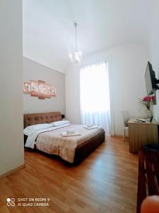 En eller flere senge i et værelse på El Dorado Vatican