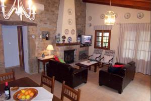 a living room filled with furniture and a fireplace at Serelleta in Pollença