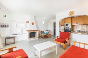 a living room with a couch and a table at Oura Parque Apartamentos Turisticos in Albufeira