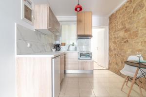 a kitchen with white cabinets and a counter top at 1 BedRoom Apartment Opposite Medical Center in Heraklio Town +76 photos