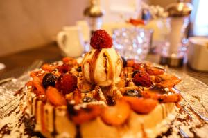 a dessert with fruit and ice cream on a table at Halvard Hotel in Douglas
