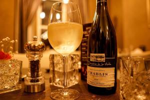 a bottle of wine and a glass on a table at Halvard Hotel in Douglas