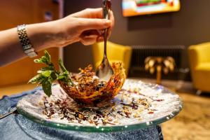 a person eating a bowl with a spoon at Halvard Hotel in Douglas