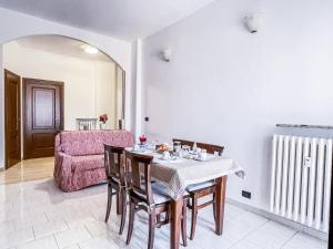 a dining room with a table and chairs and a couch at MYHOUSE INN TOGLIATTI - Affitti Brevi Italia in Collegno