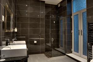 a bathroom with a sink and a shower at Halvard Hotel in Douglas