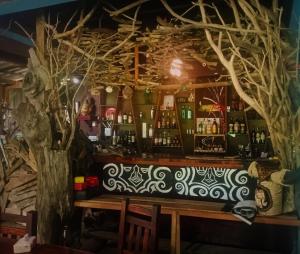 a bar with a fake tree behind it at Ko Yao Noi Sabai Bungalows in Ko Yao Noi