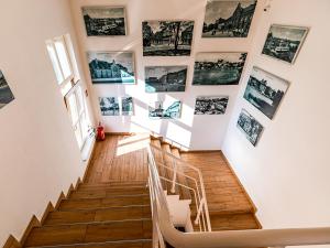 a staircase with pictures on the wall at SSW Grand Hostel Iława in Iława