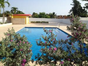 a swimming pool in a yard with flowers at Arecibo Inn in Arecibo