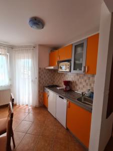 a kitchen with orange cabinets and a sink at Villa Bonaca in Umag