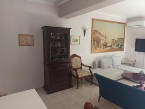 a living room with a couch and a chair at OLD ZAKYNTHOS GALLERY GIO 2 in Zakynthos Town