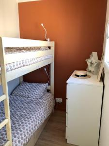 a childs bedroom with a bunk bed and a desk at Charmant T2, hyper-centre, à 50m de la plage ! in Le Touquet-Paris-Plage +8 photos