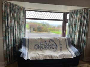 a bed in a room with a window at Strand Awaits Holiday Home in Cork
