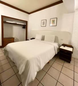 A bed or beds in a room at Delphin Beach Hotel