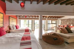 a bedroom with two beds and a couch at Casa Acento in Valle de Bravo +163 photos