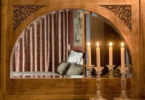 a mirror with two candles in front of a room at B&B Royal Swans - Adults-Only Boutique Stay in Bruges in Bruges