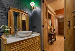a bathroom with a bowl sink and a stone wall at B&B Royal Swans - Adults-Only Boutique Stay in Bruges in Bruges
