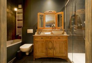 a bathroom with a wooden sink and a toilet at B&B Royal Swans - Adults-Only Boutique Stay in Bruges in Bruges +46 photos