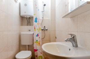 a bathroom with a sink and a toilet at Apartment Ronchi in Dubrovnik