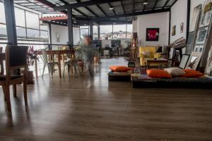 a man sitting at a table in a room with furniture at La Casa de Manuel Hotel-Boutique in Loja