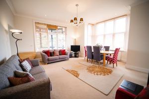 a living room with a couch and a table at Tudor Villas Apartment, Cromer in Cromer