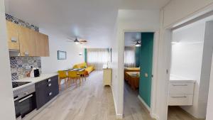 a kitchen and living room with a dining room at Apartamentos Eldorado in Lloret de Mar