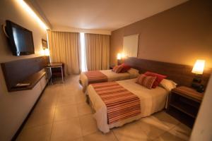 Postel nebo postele na pokoji v ubytování Hotel Estilo MB - Villa Carlos Paz