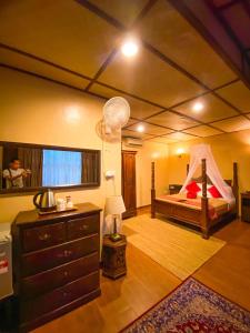 a bedroom with a bed and a dresser in a room at Ombak Dive Resort Perhentian Island in Perhentian Islands