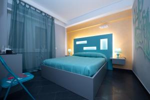 a bedroom with a blue bed and a window at Dream B&B Roma in Rome