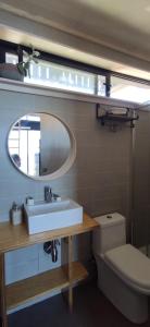 a bathroom with a sink and a mirror and a toilet at Almar de Matanzas Tiny in Boca Pupuya