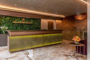 eine Lobby eines Hotels mit einer grünen Wand in der Unterkunft Hotel Ariston in Mailand