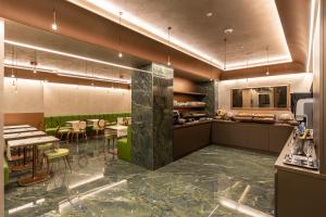 a restaurant with tables and chairs in a room at Hotel Ariston in Milan