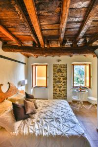 a bedroom with a large bed with wooden ceilings at Perla del Marinaio in Riomaggiore