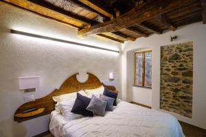 a bedroom with a large bed with blue pillows at Perla del Marinaio in Riomaggiore