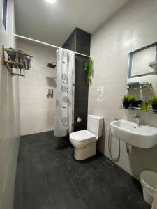 a bathroom with a toilet and a sink at The Opal Suite Troika Kota Bharu 1 Bedroom in Kota Bharu