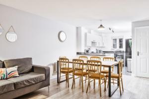 a living room with a table and chairs and a couch at 5 Bed House in Gloucester in Hucclecote