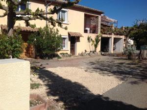 a house with a tree in front of it at Gite d'Isa in Saint-Remèze