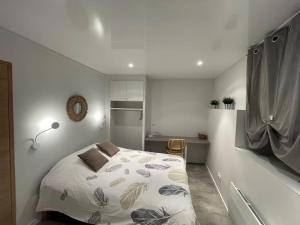 a bedroom with a bed in a white room at Casa Jaubertie - Appartement cosy et chaleureux refait à neuf - HYPER CENTRE BRIVE in Brive-la-Gaillarde