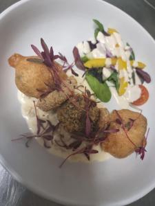 a white plate of food with a salad on it at Grampian Hotel in Keith