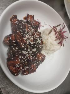 a plate of food with meat and rice on a table at Grampian Hotel in Keith