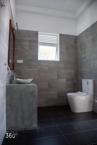 a bathroom with two sinks and a toilet and a window at Villa 360 in Talpe +15 photos